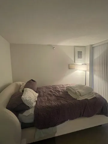 a bedroom with a bed and window