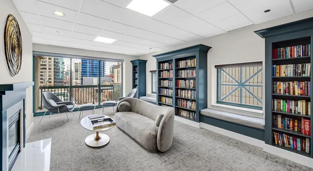 a living room with furniture and a book shelf