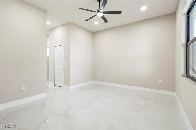 an empty room with windows and closet