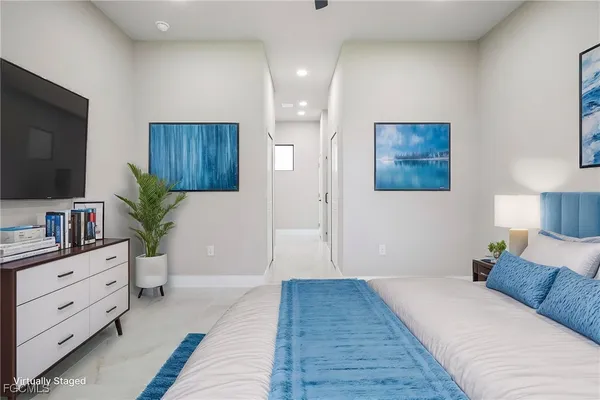 a bedroom with a large bed and a flat screen tv
