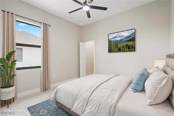 a bedroom with a bed and a potted plant