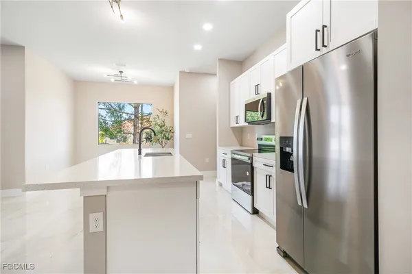 a kitchen with stainless steel appliances a refrigerator and a stove