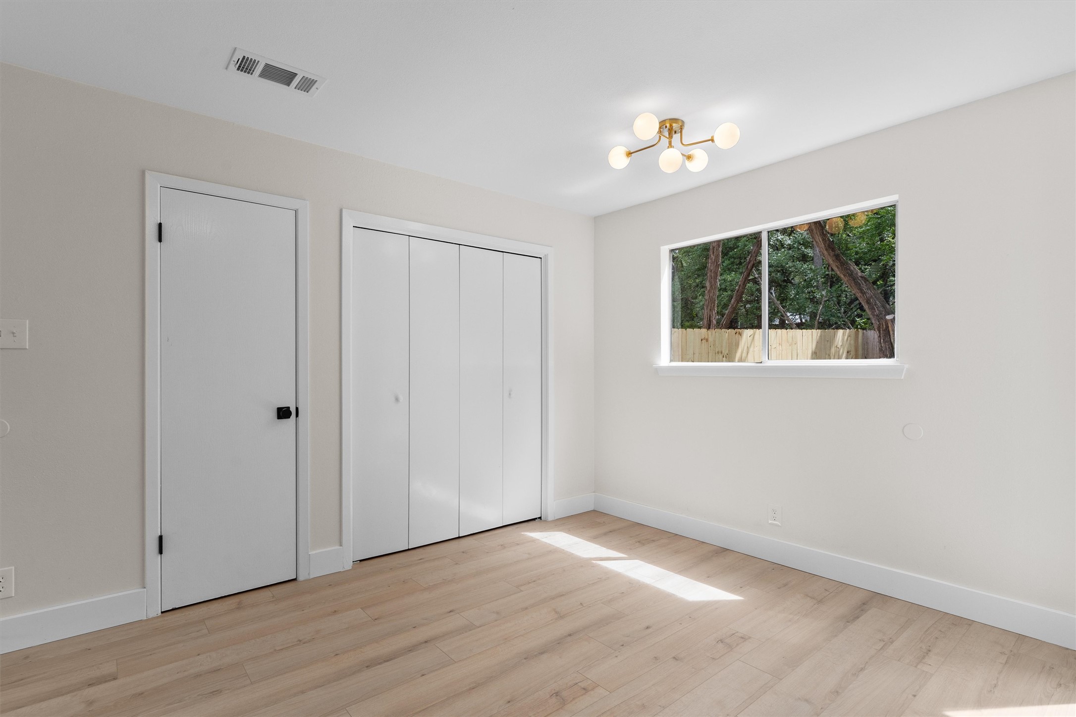 1707 Waterloo Trail Austin, TX 78704 - Photo 11 of 39 Unfurnished bedroom featuring light wood-type flooring and a closet