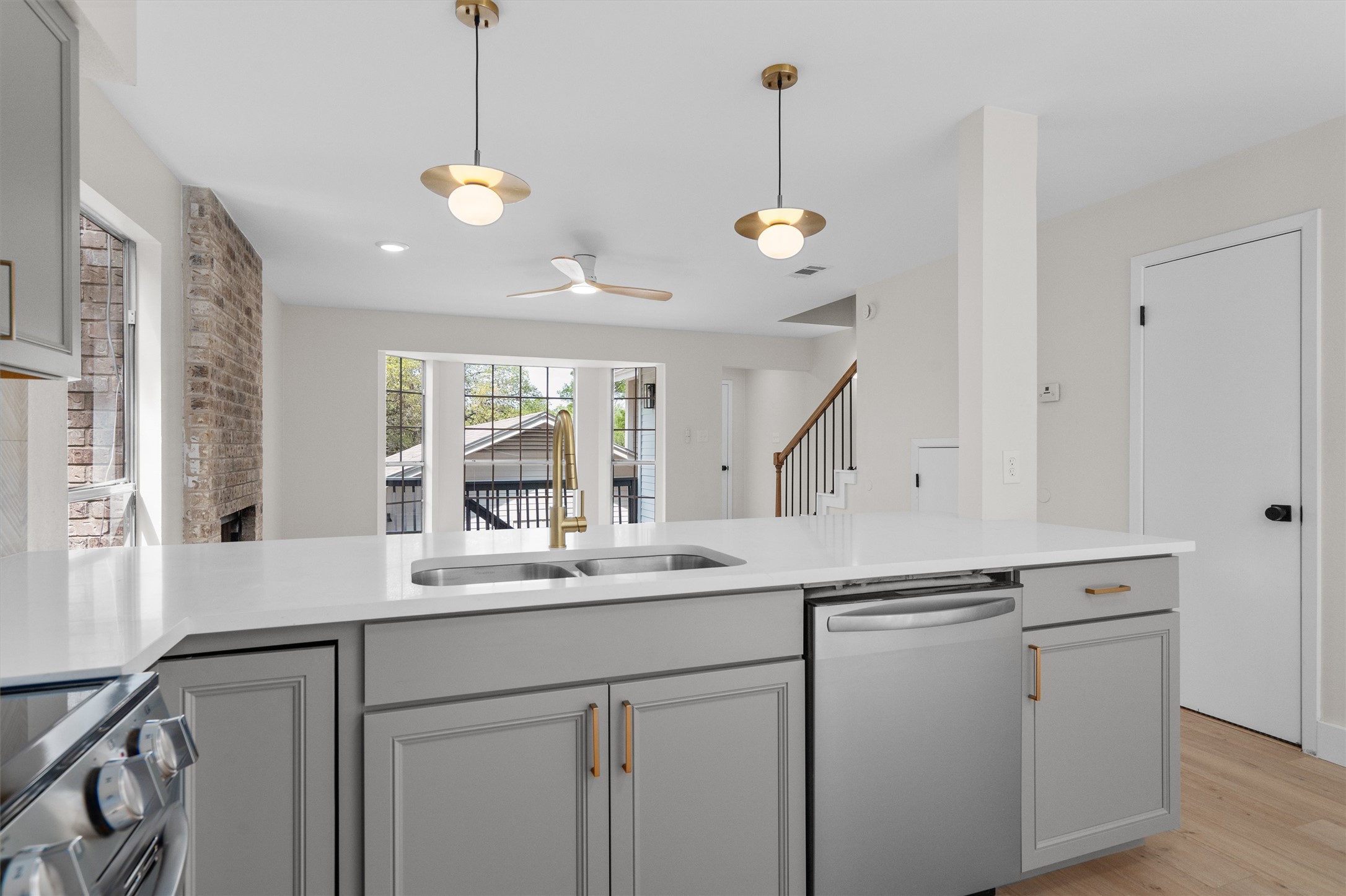 1707 Waterloo Trail Austin, TX 78704 - Photo 13 of 39 Kitchen featuring stainless steel appliances, gray cabinetry, light wood finished floors, hanging light fixtures, and ceiling fan