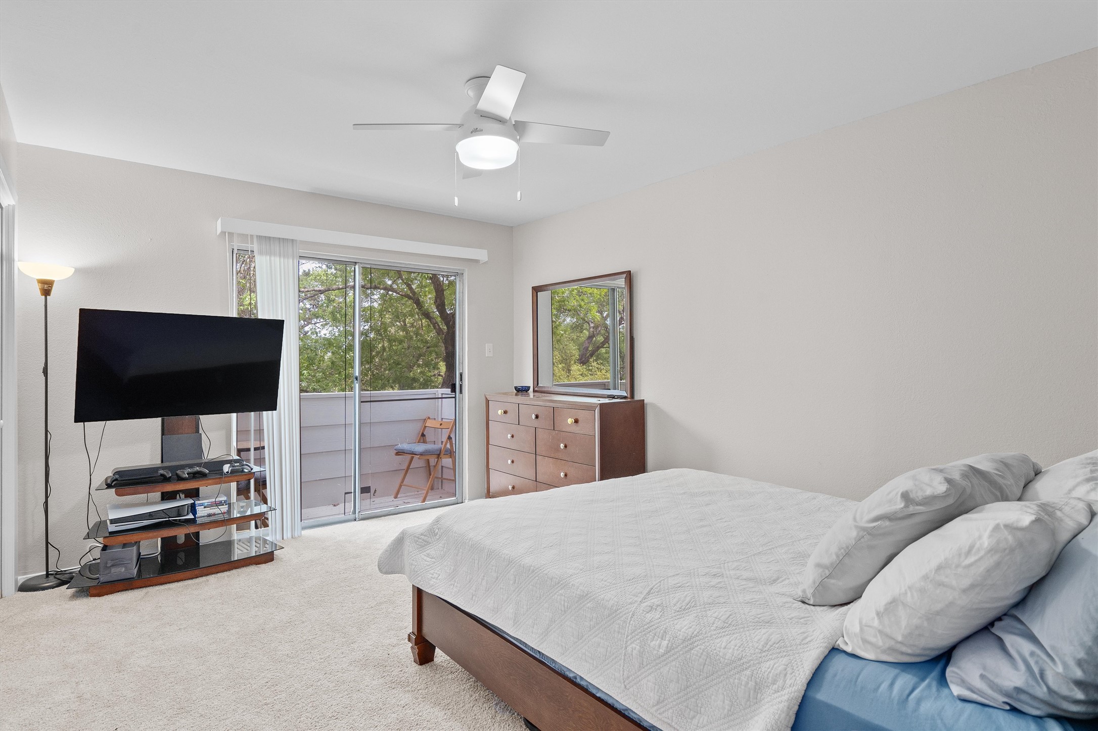 1707 Waterloo Trail Austin, TX 78704 - Photo 34 of 39 Bedroom with access to exterior, light carpet, and a ceiling fan