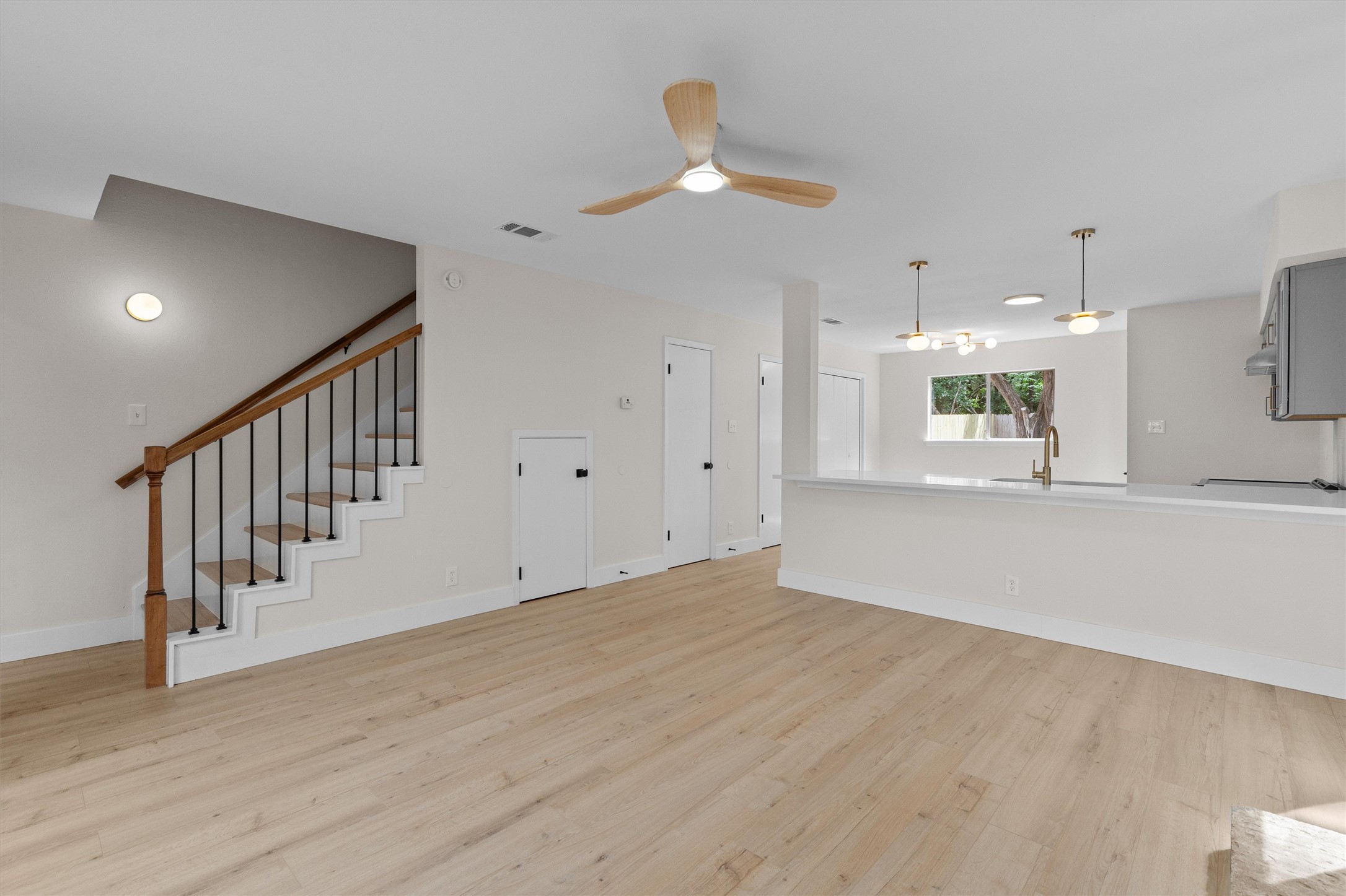 1707 Waterloo Trail Austin, TX 78704 - Photo 6 of 39 Unfurnished living room with light wood-type flooring and ceiling fan