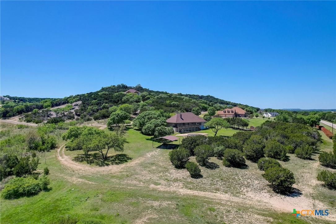1214 Windy Hill Road Salado, TX 76571 - Photo 13 of 18 a view of a garden with a building in the background