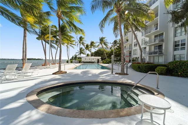 a view of swimming pool with outdoor seating and plants