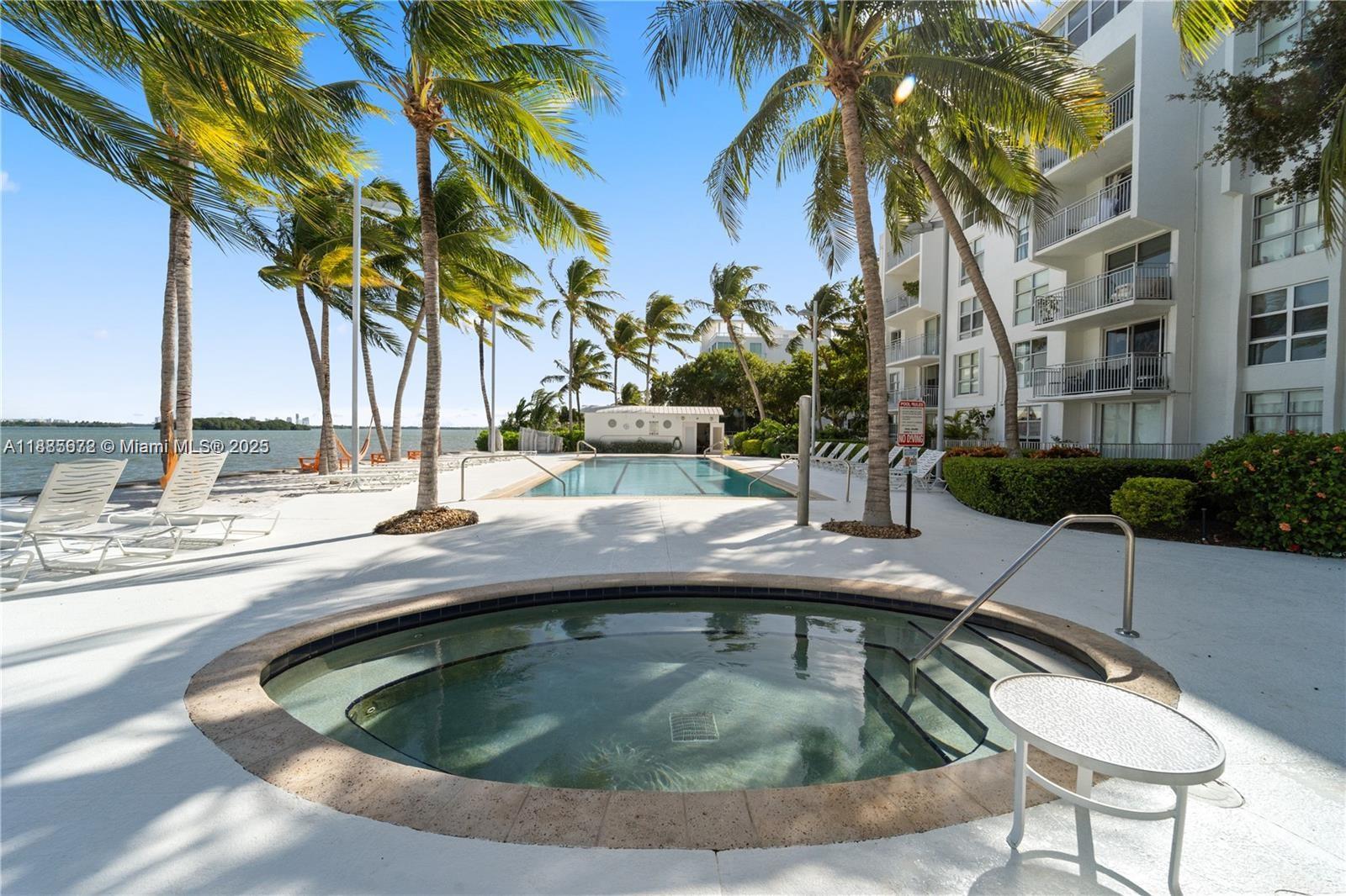 650 Northeast 64th Street, Unit GPH4 Miami, FL 33138 - Photo 18 of 24 a view of swimming pool with outdoor seating and plants