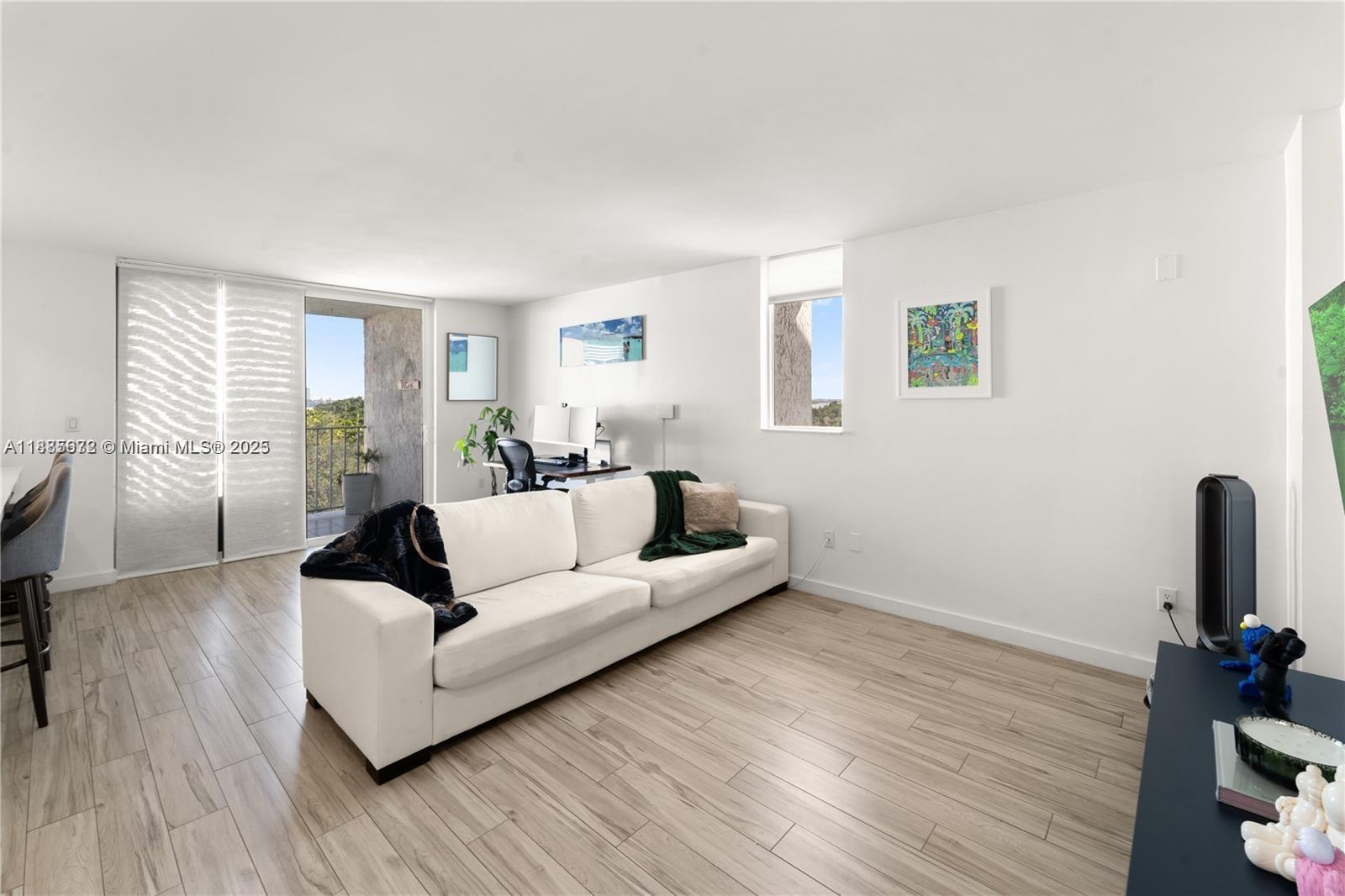 650 Northeast 64th Street, Unit GPH4 Miami, FL 33138 - Photo 2 of 24 a living room with furniture and a wooden floor