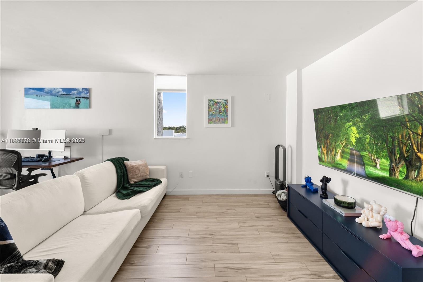 650 Northeast 64th Street, Unit GPH4 Miami, FL 33138 - Photo 3 of 24 a living room with furniture and a flat screen tv