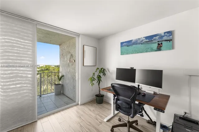 a view of a workspace with furniture and wooden floor