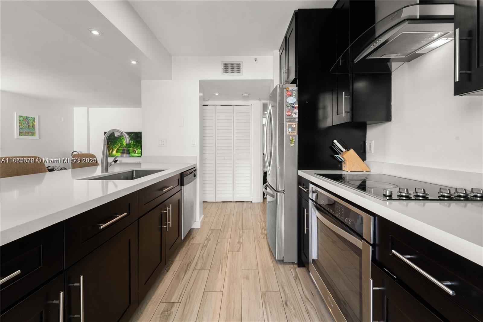 650 Northeast 64th Street, Unit GPH4 Miami, FL 33138 - Photo 7 of 24 a kitchen with stainless steel appliances a sink dishwasher stove and refrigerator