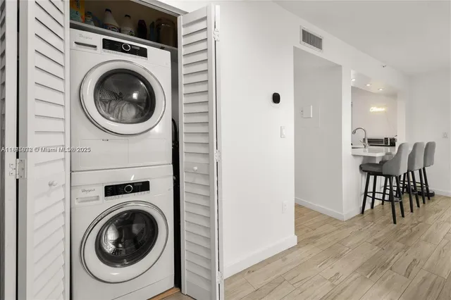 a view of a hallway with washer and dryer
