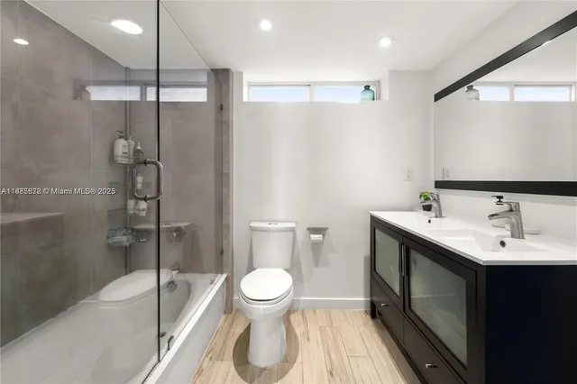 a bathroom with a toilet sink and shower