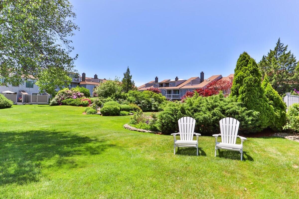 500 Ocean Street, Unit 153 Hyannis, MA 02601 - Photo 10 of 46 a white bench sitting in a grassy field