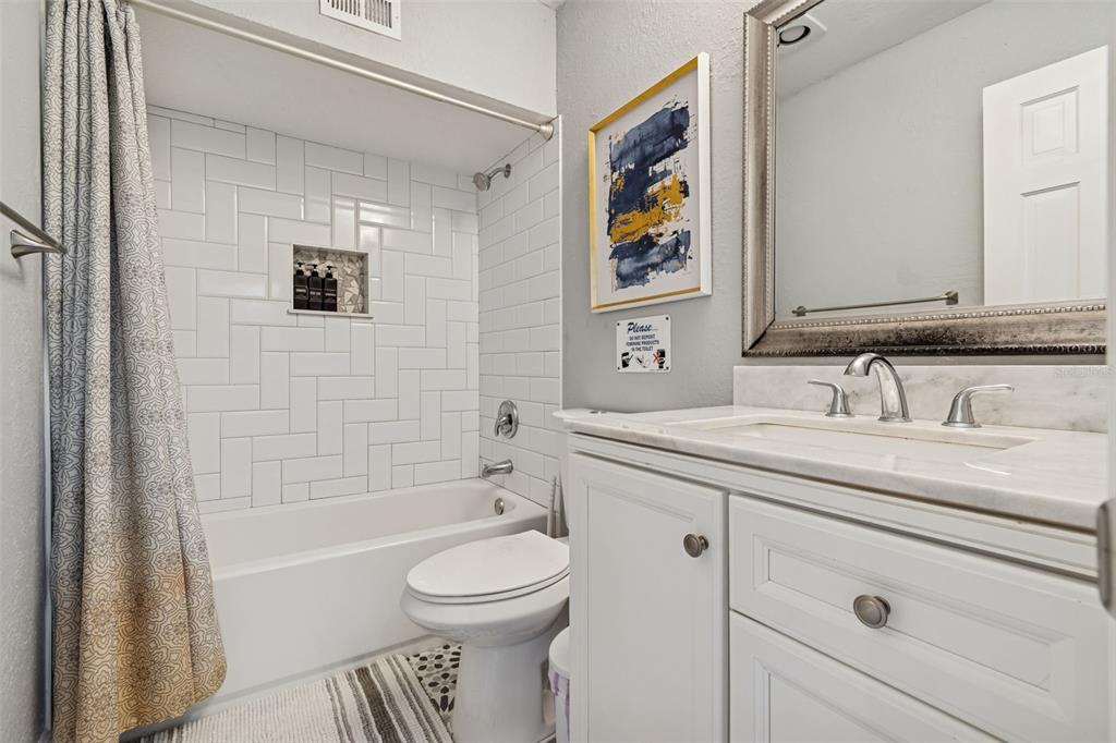 330 6th Avenue Indian Rocks Beach, FL 33785 - Photo 14 of 52 a bathroom with a granite countertop sink toilet and shower