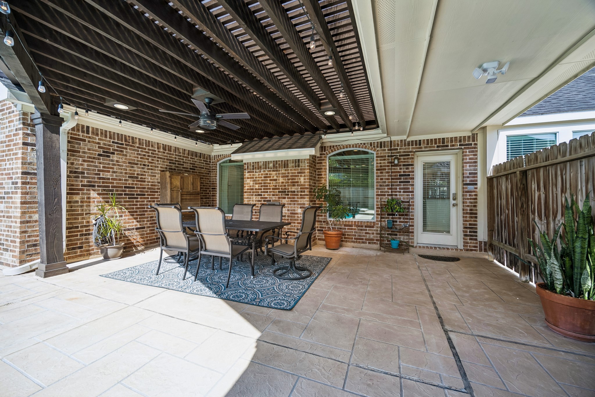 5718 Brennan Ridge Lane Katy, TX 77450 - Photo 31 of 42 OUTDOOR LIVING AT ITS FINEST: Over 500 square feet of covered patio space creates the perfect setting for outdoor dining, entertaining, and relaxing year-round beneath the custom pergola-style cover.