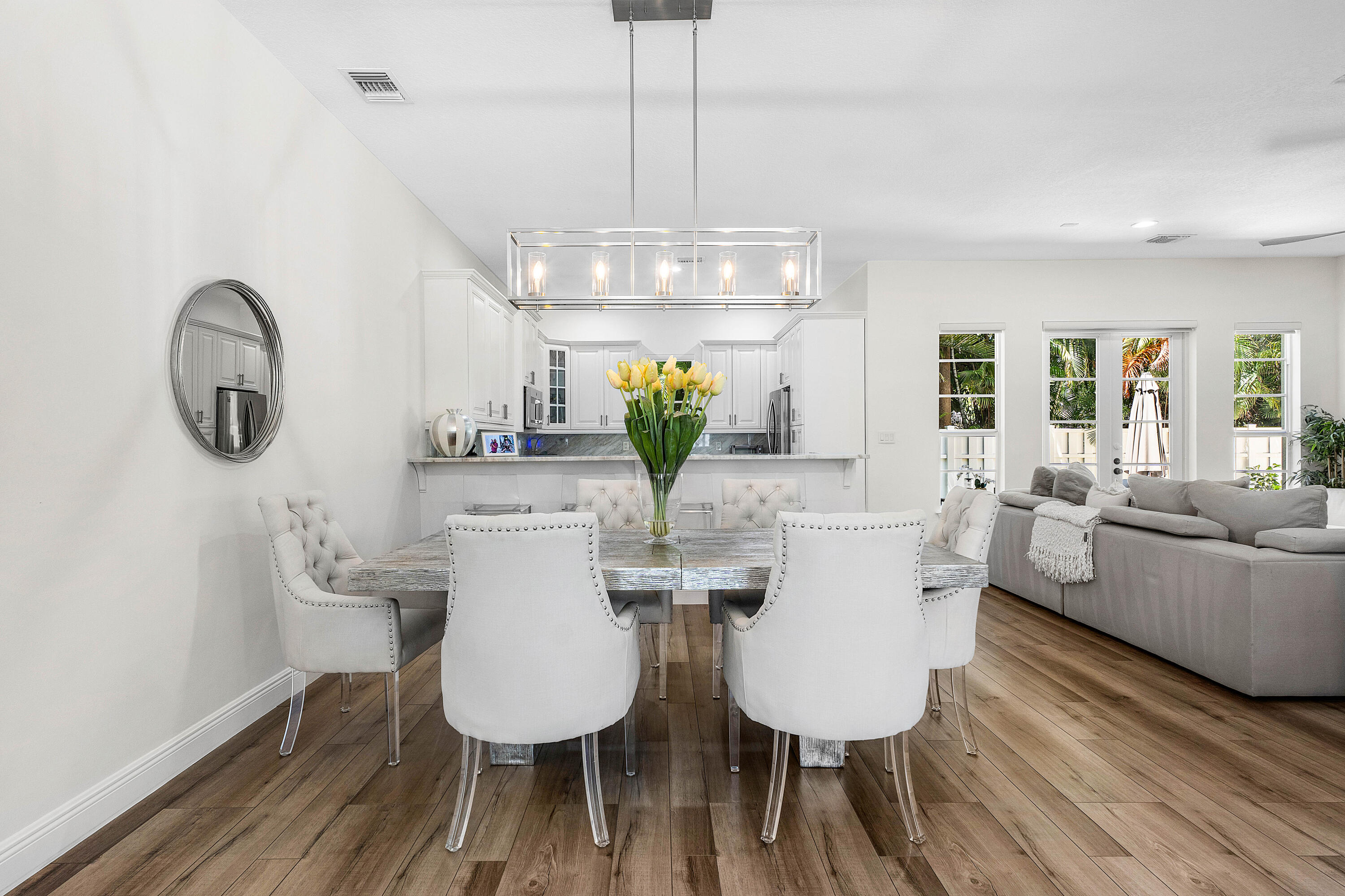 121 Via Poinciana Lane Boca Raton, FL 33487 - Photo 11 of 59 a view of a dining room with furniture a chandelier and wooden floor