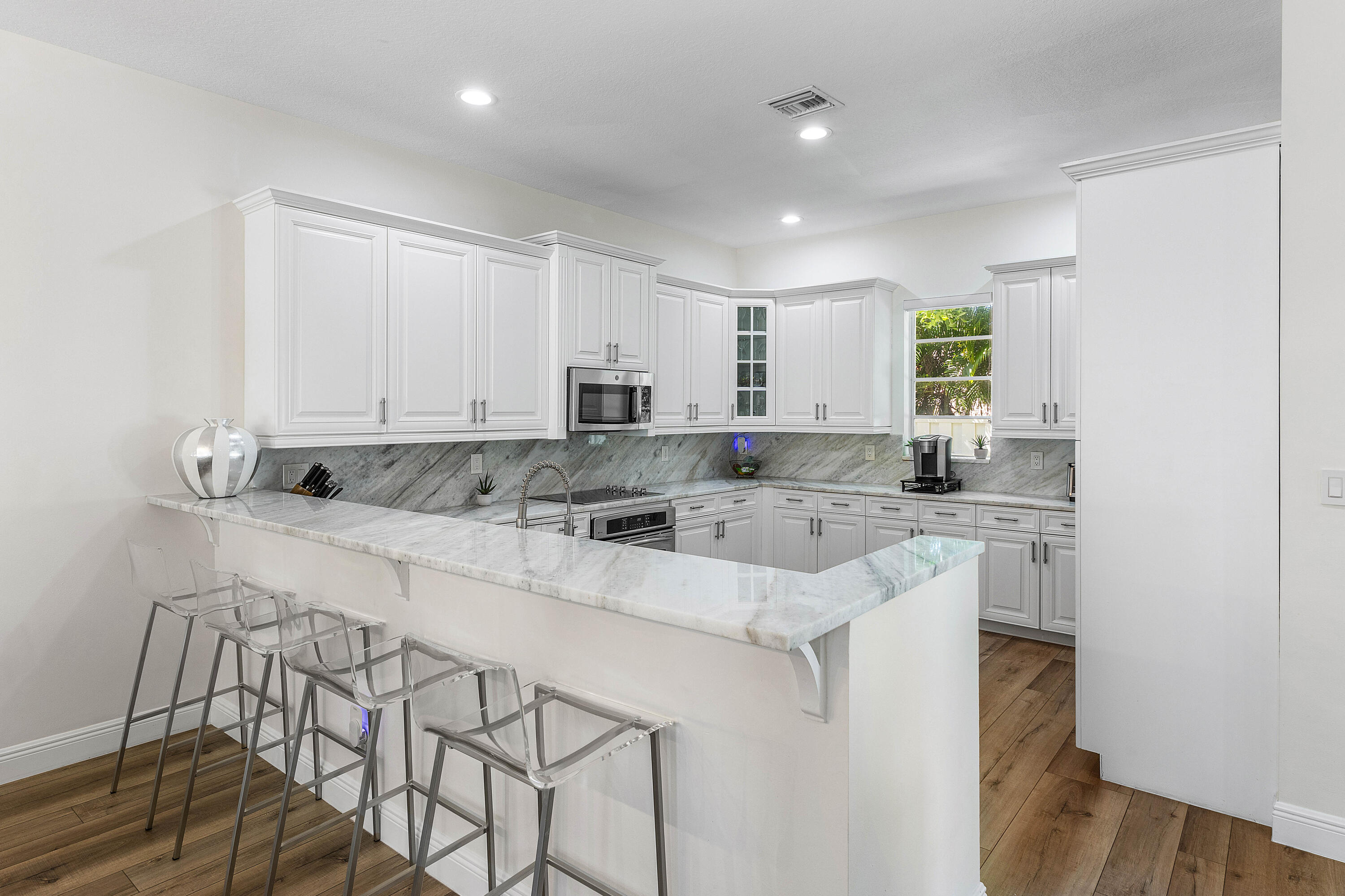 121 Via Poinciana Lane Boca Raton, FL 33487 - Photo 14 of 59 a kitchen with stainless steel appliances granite countertop a white cabinets and a granite counter tops