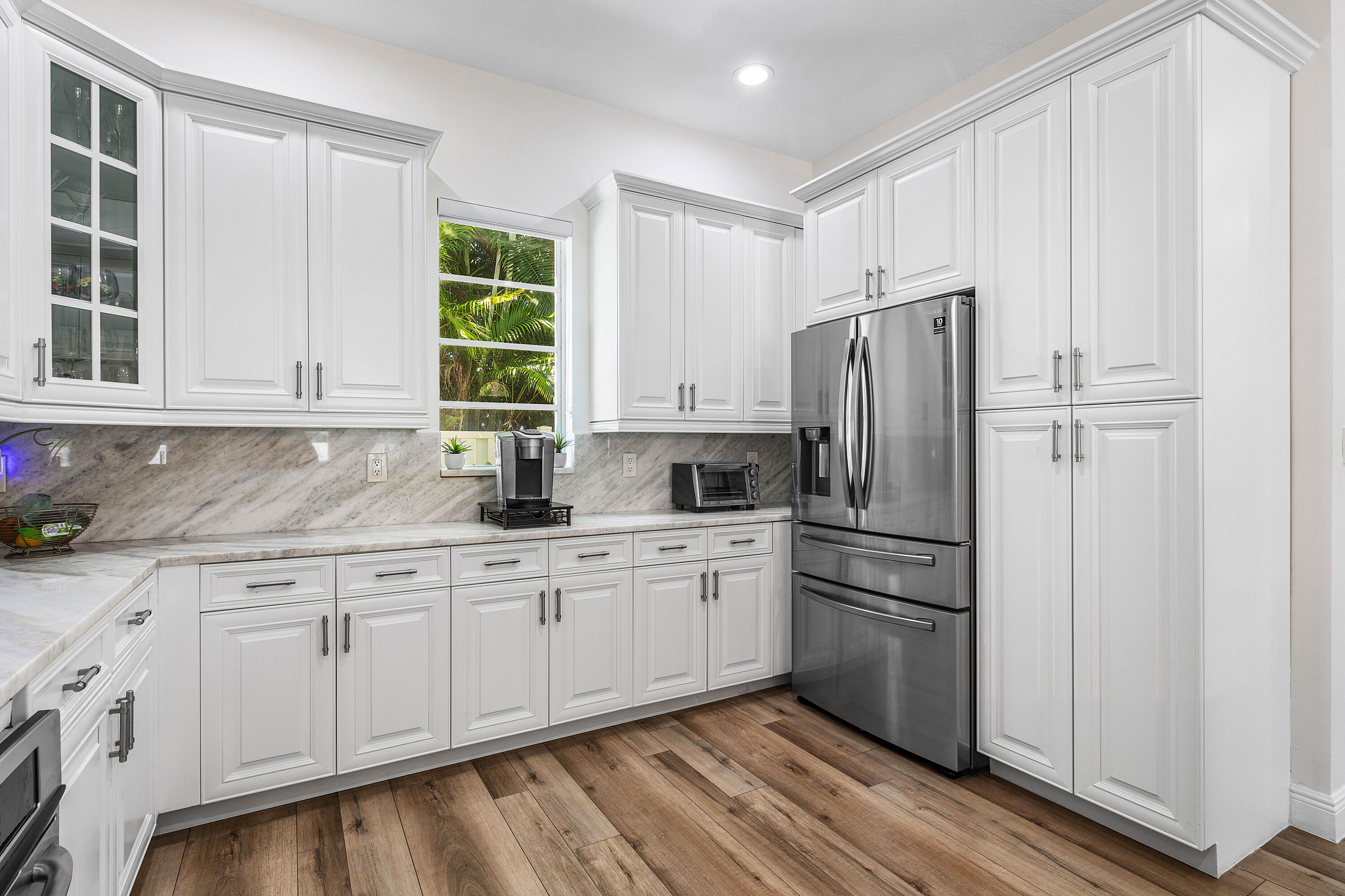 121 Via Poinciana Lane Boca Raton, FL 33487 - Photo 17 of 59 a kitchen with stainless steel appliances granite countertop a refrigerator sink and cabinets