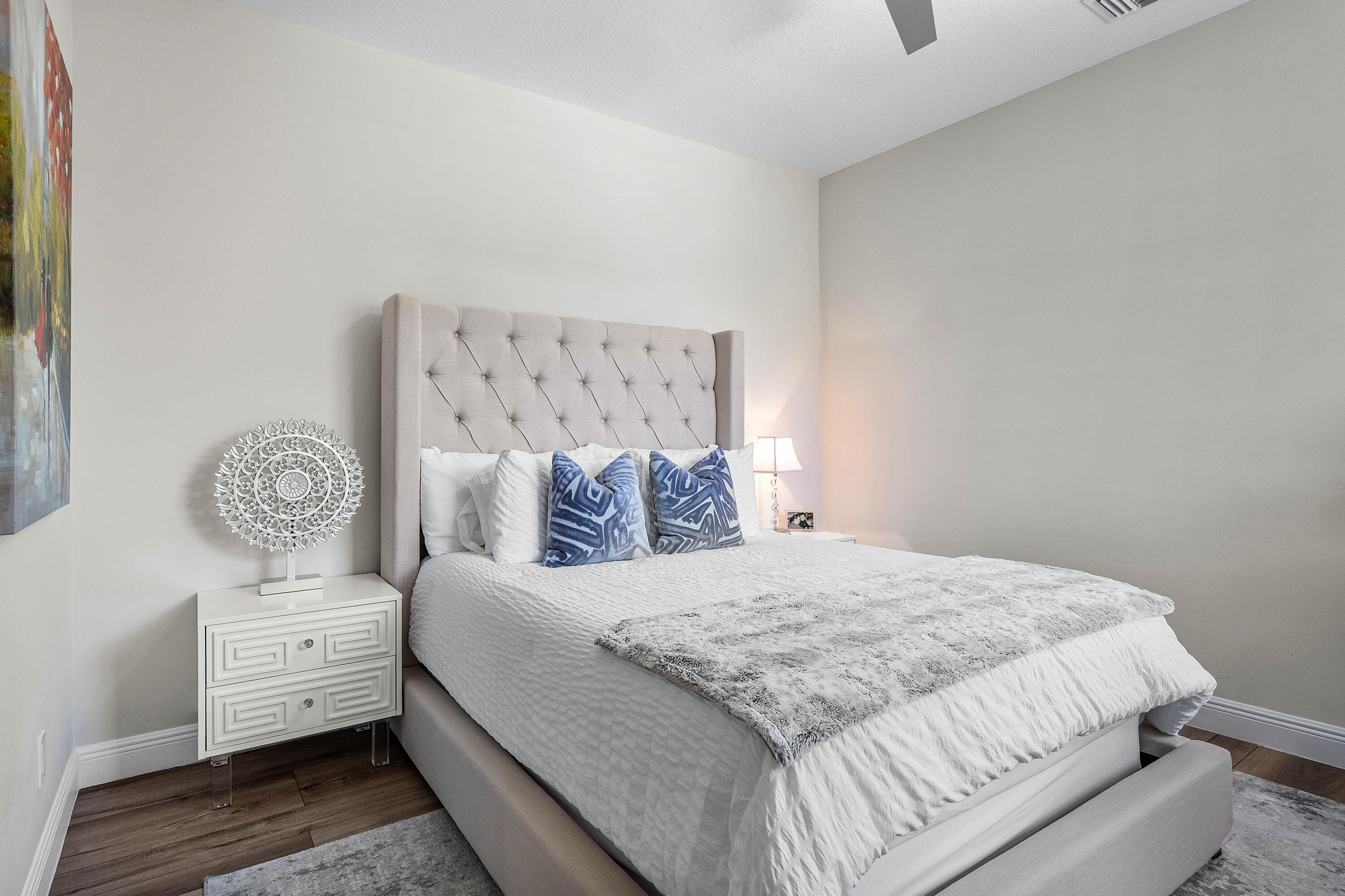 121 Via Poinciana Lane Boca Raton, FL 33487 - Photo 26 of 59 a bedroom with a bed and a lamp