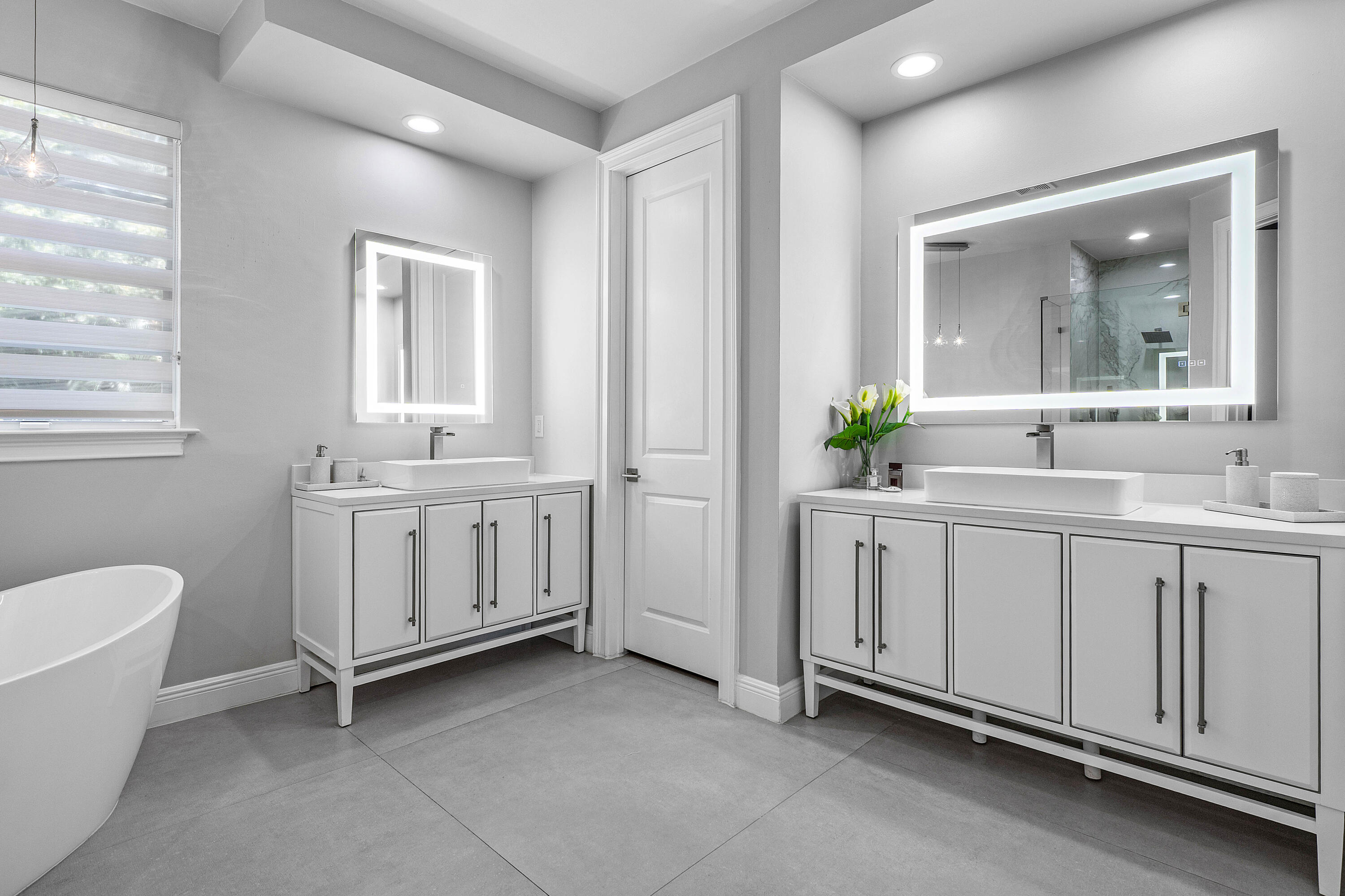 121 Via Poinciana Lane Boca Raton, FL 33487 - Photo 29 of 59 a bathroom with a double vanity sink a mirror and a bathtub