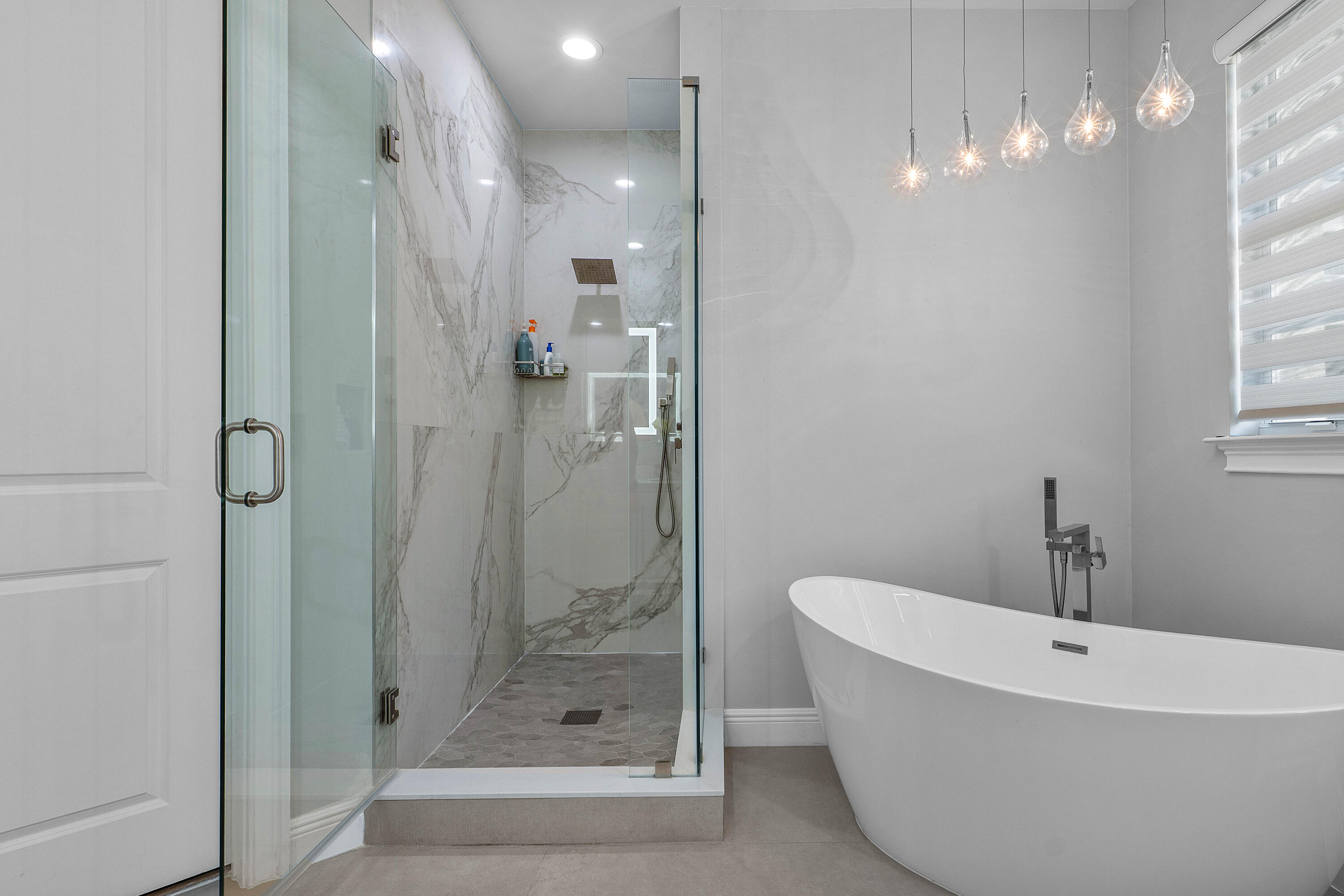 121 Via Poinciana Lane Boca Raton, FL 33487 - Photo 32 of 59 a bathroom with a bathtub and shower