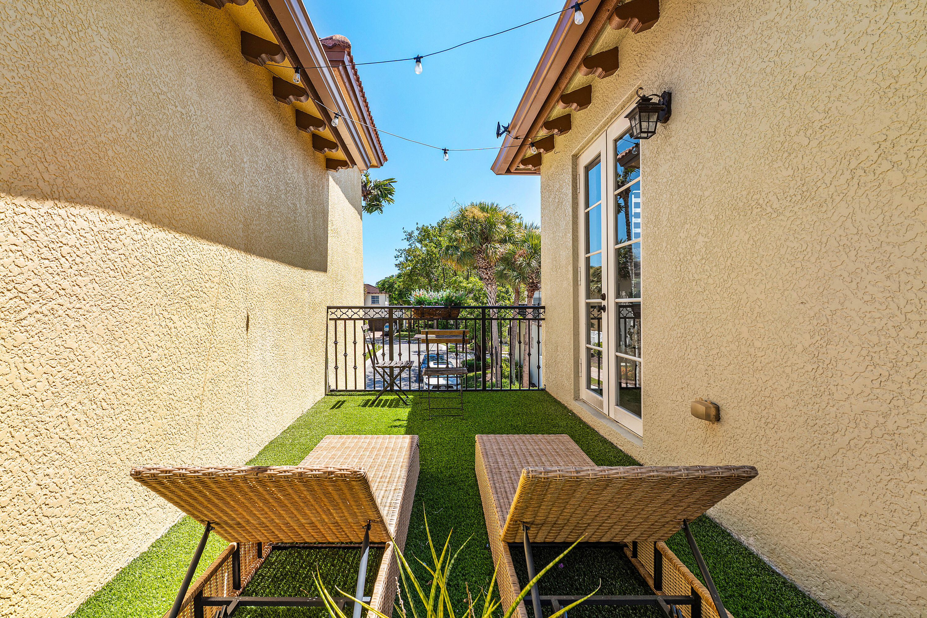 121 Via Poinciana Lane Boca Raton, FL 33487 - Photo 35 of 59 a view of balcony with two chairs and a potted plant