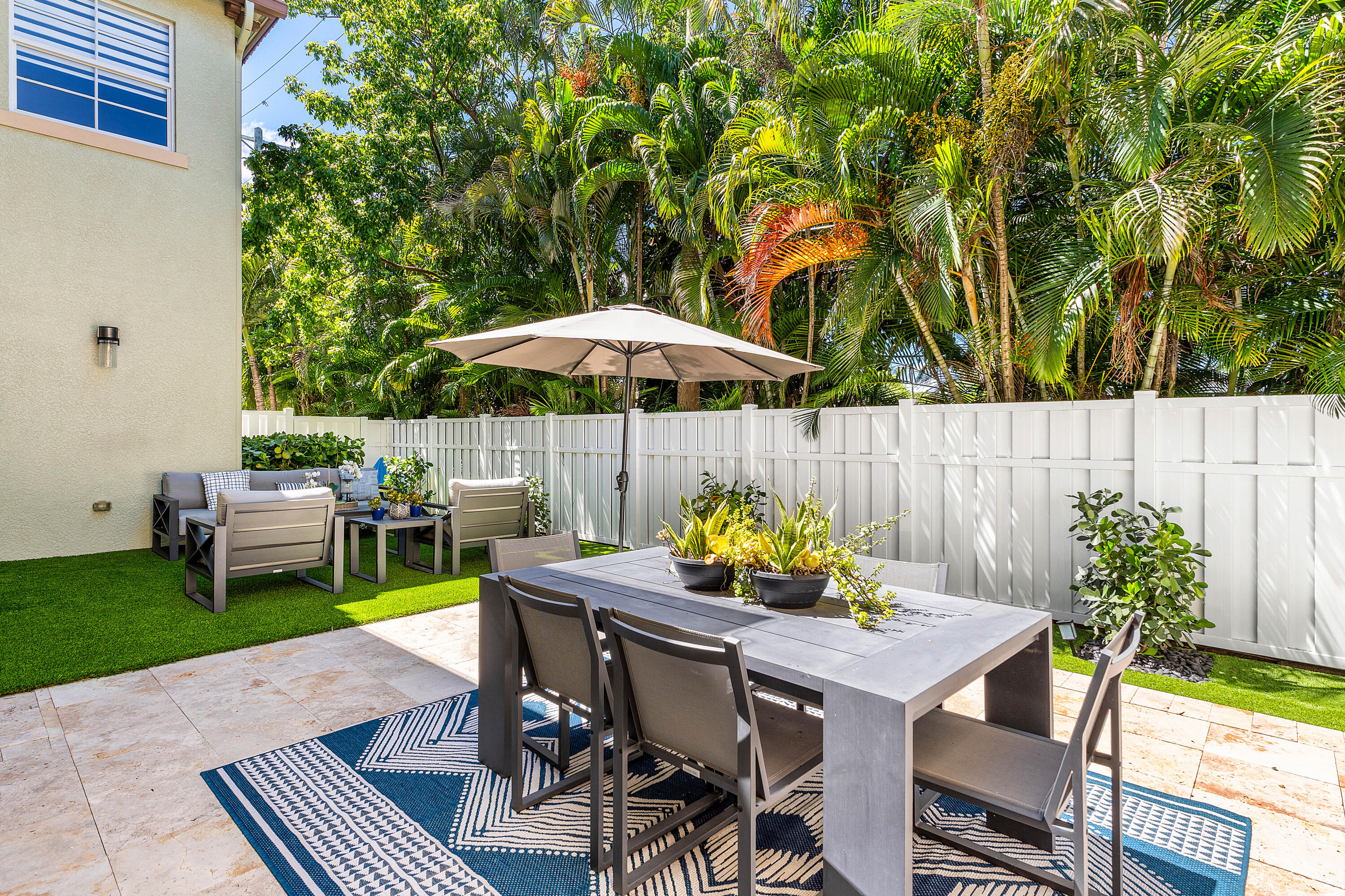 121 Via Poinciana Lane Boca Raton, FL 33487 - Photo 38 of 59 a view of outdoor dining space with a table and chairs