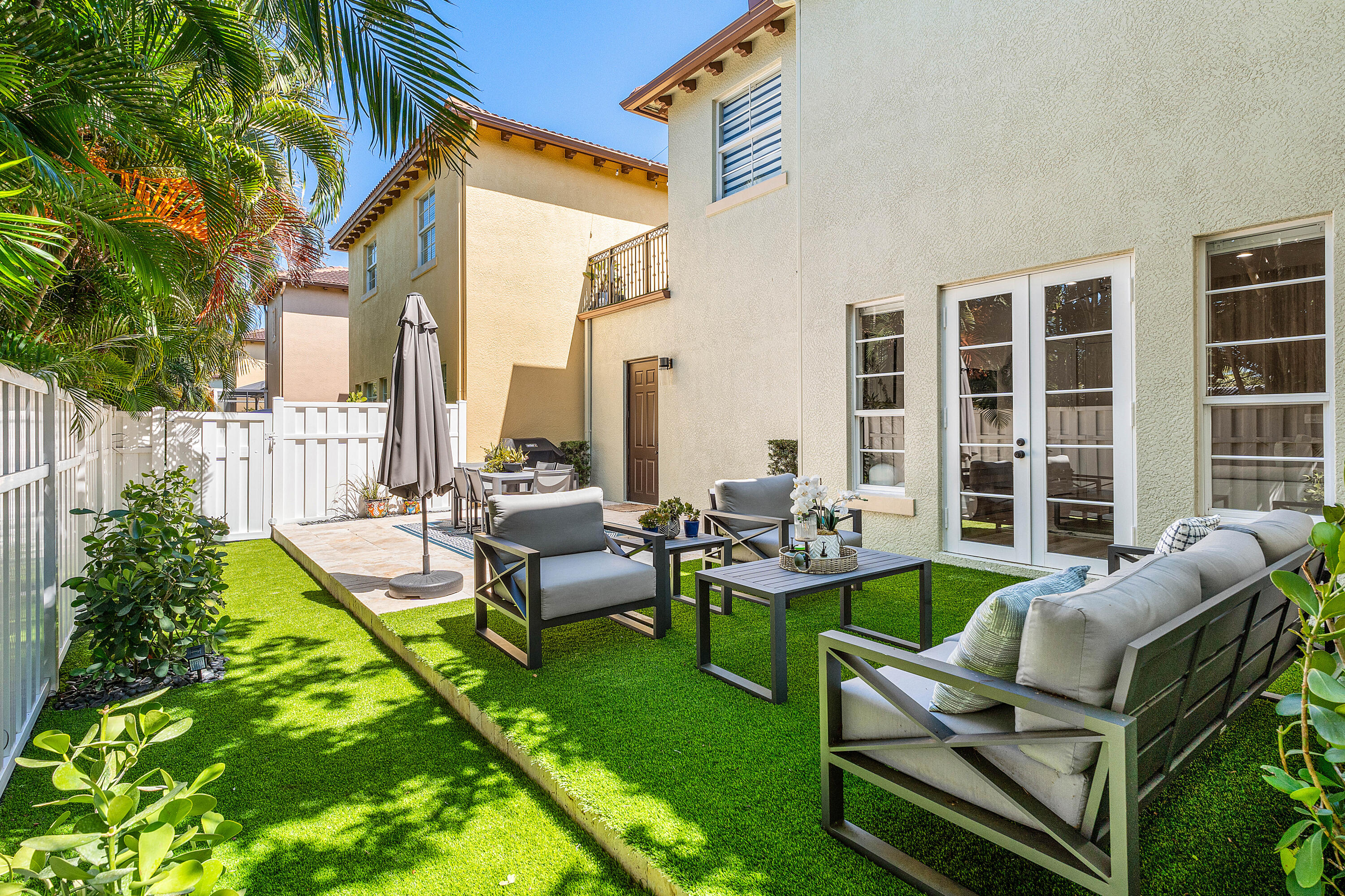 121 Via Poinciana Lane Boca Raton, FL 33487 - Photo 41 of 59 a view of a house with backyard sitting area and garden