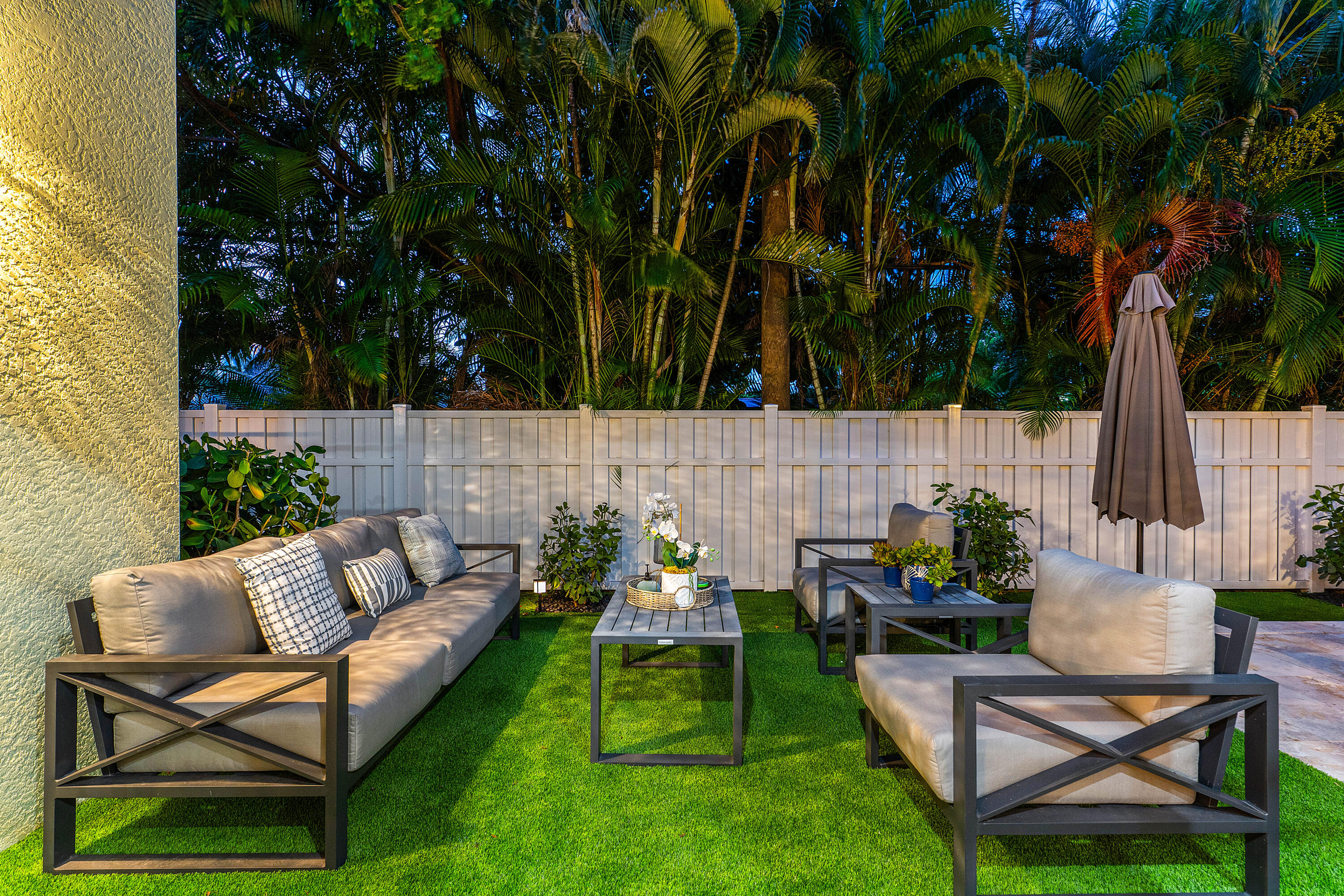 121 Via Poinciana Lane Boca Raton, FL 33487 - Photo 49 of 59 a backyard of a house with table and chairs