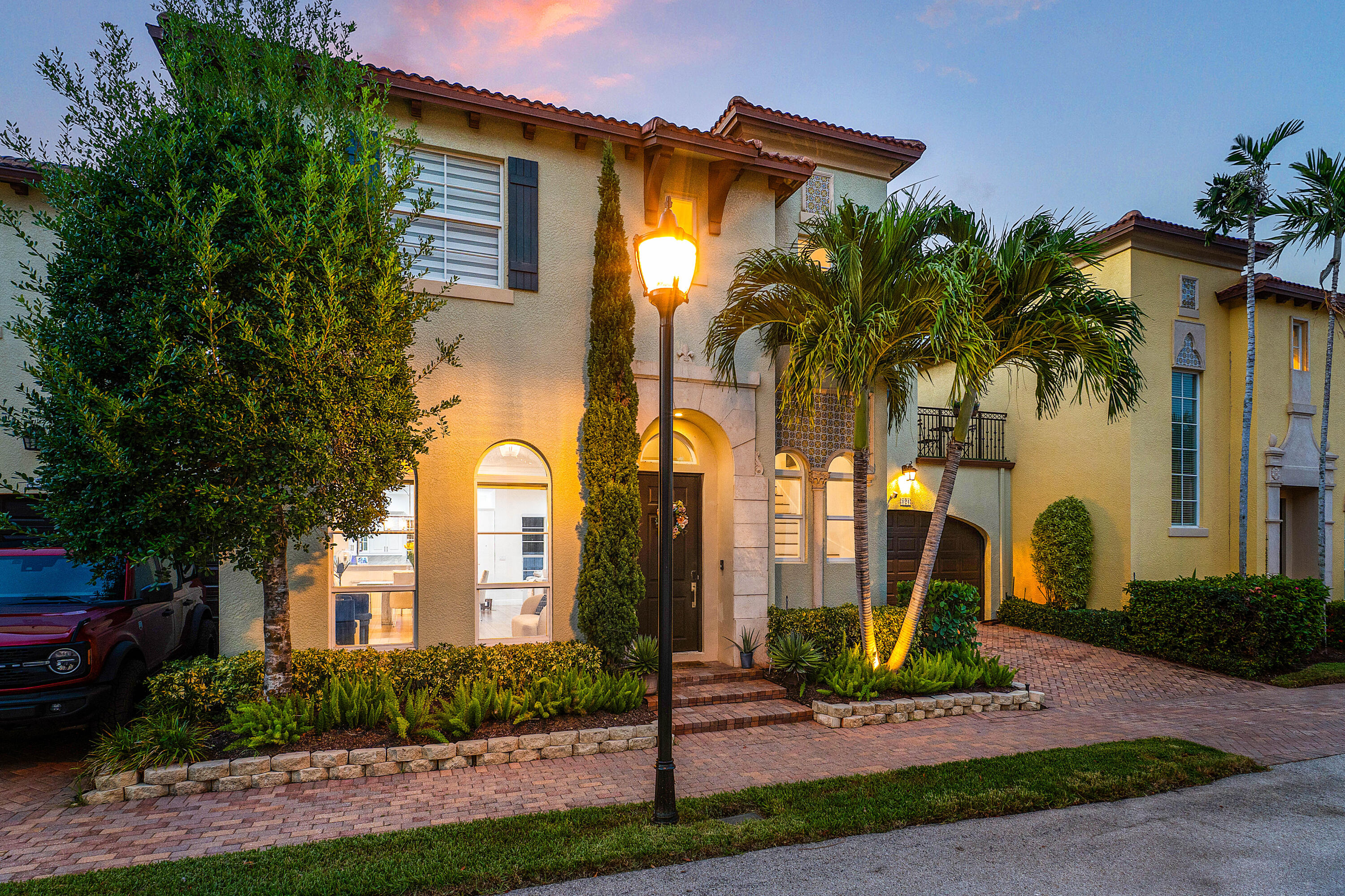 121 Via Poinciana Lane Boca Raton, FL 33487 - Photo 50 of 59 a front view of a house with garden and plants