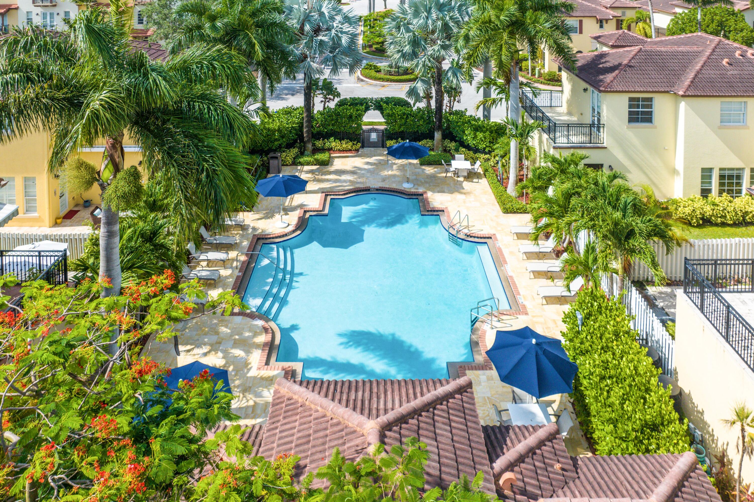 121 Via Poinciana Lane Boca Raton, FL 33487 - Photo 52 of 59 a view of a patio with couches table and chairs and potted plants