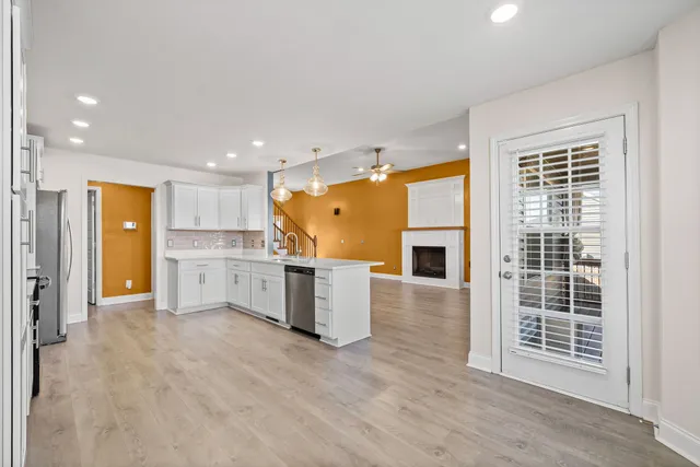 a view of a kitchen with a sink and a large window
