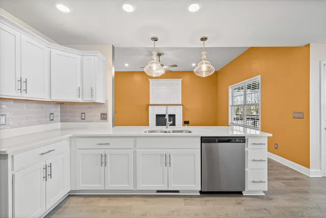 a kitchen with cabinets and window