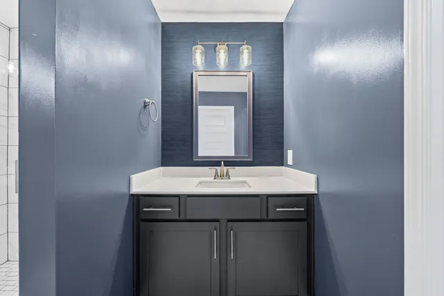 a bathroom with a sink and a mirror