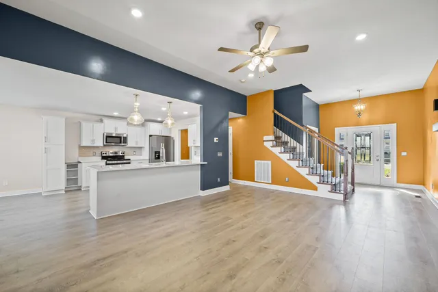 a view of a kitchen with a sink and a refrigerator
