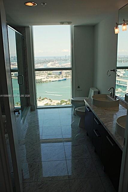 253 Northeast 2nd Street, Unit 4303 Miami, FL 33132 - Photo 18 of 35 a room with washing machine and mirrors