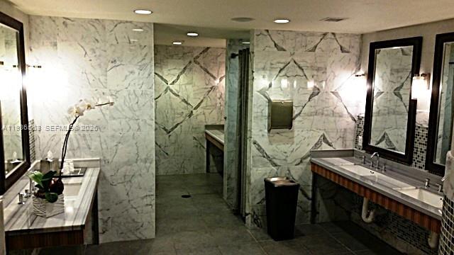 253 Northeast 2nd Street, Unit 4303 Miami, FL 33132 - Photo 31 of 35 a bathroom with a mirror and a shower