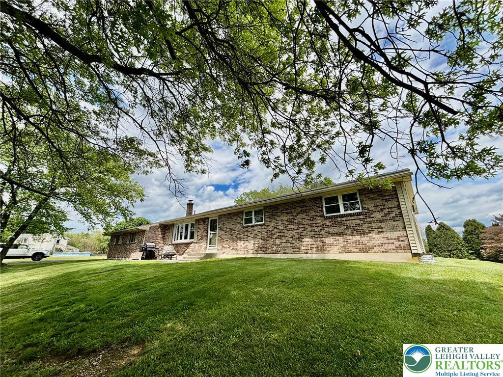 This residence offers a spacious private yard and durable brick construction.