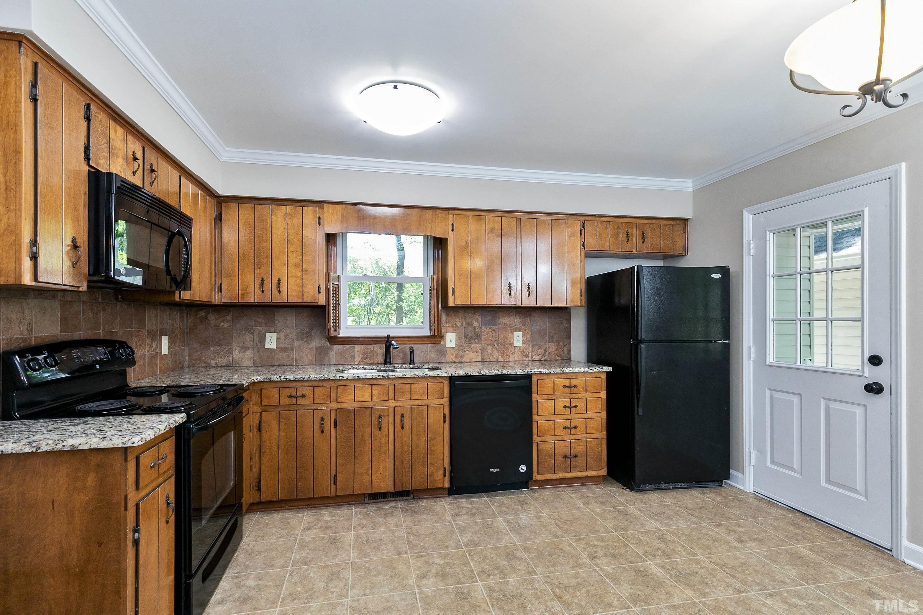 1104 Apache Lane Apex, NC 27502 - Photo 19 of 29 a kitchen with stainless steel appliances granite countertop a refrigerator a stove a sink and a microwave