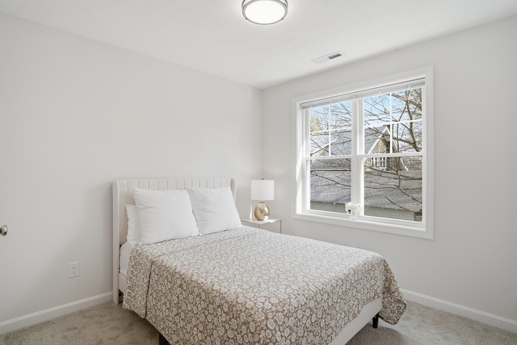 21 Ambrose Way, Unit 21 Shirley, MA 01464 - Photo 15 of 31 a bedroom with a bed and next to a window