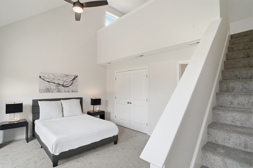 21 Ambrose Way, Unit 21 Shirley, MA 01464 - Photo 17 of 31 a bedroom with a bed and a painting on the wall
