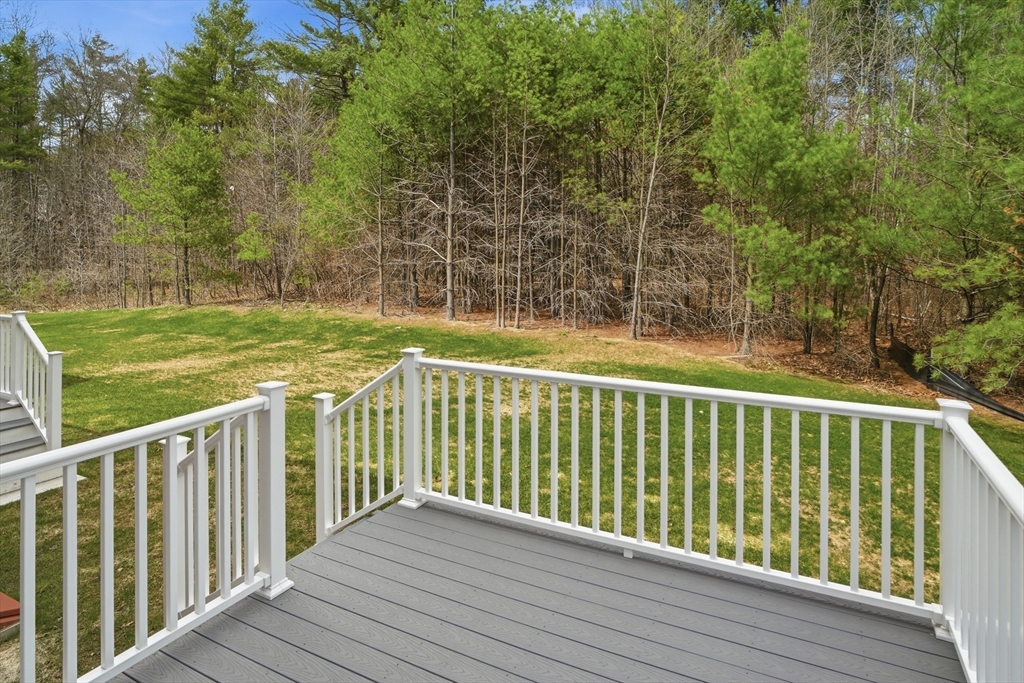 21 Ambrose Way, Unit 21 Shirley, MA 01464 - Photo 29 of 31 a view of balcony with wooden floor and fence