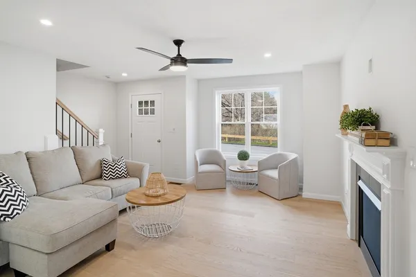 a living room with furniture and a fireplace