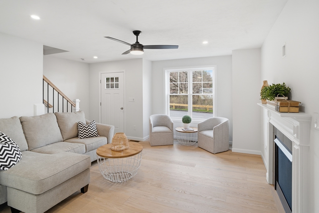 21 Ambrose Way, Unit 21 Shirley, MA 01464 - Photo 8 of 31 a living room with furniture and a fireplace