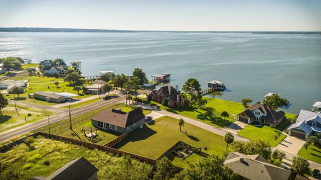 a swimming pool with trees in front of it