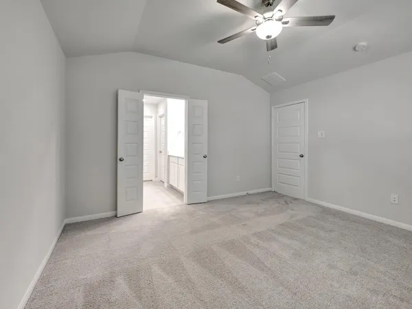a view of an empty room with a chandelier fan