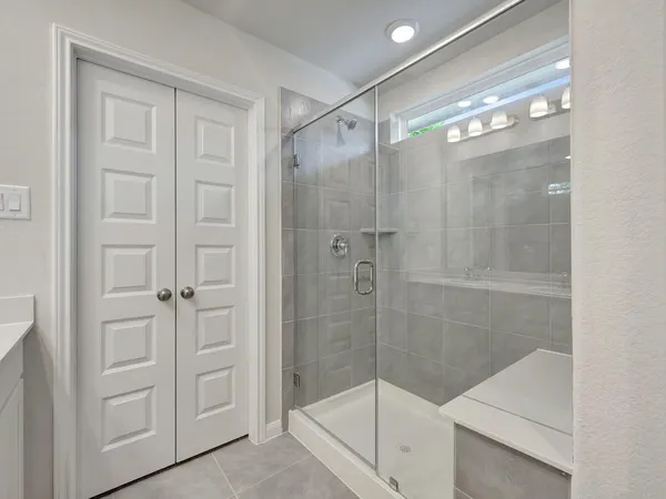 a bathroom with a glass shower door